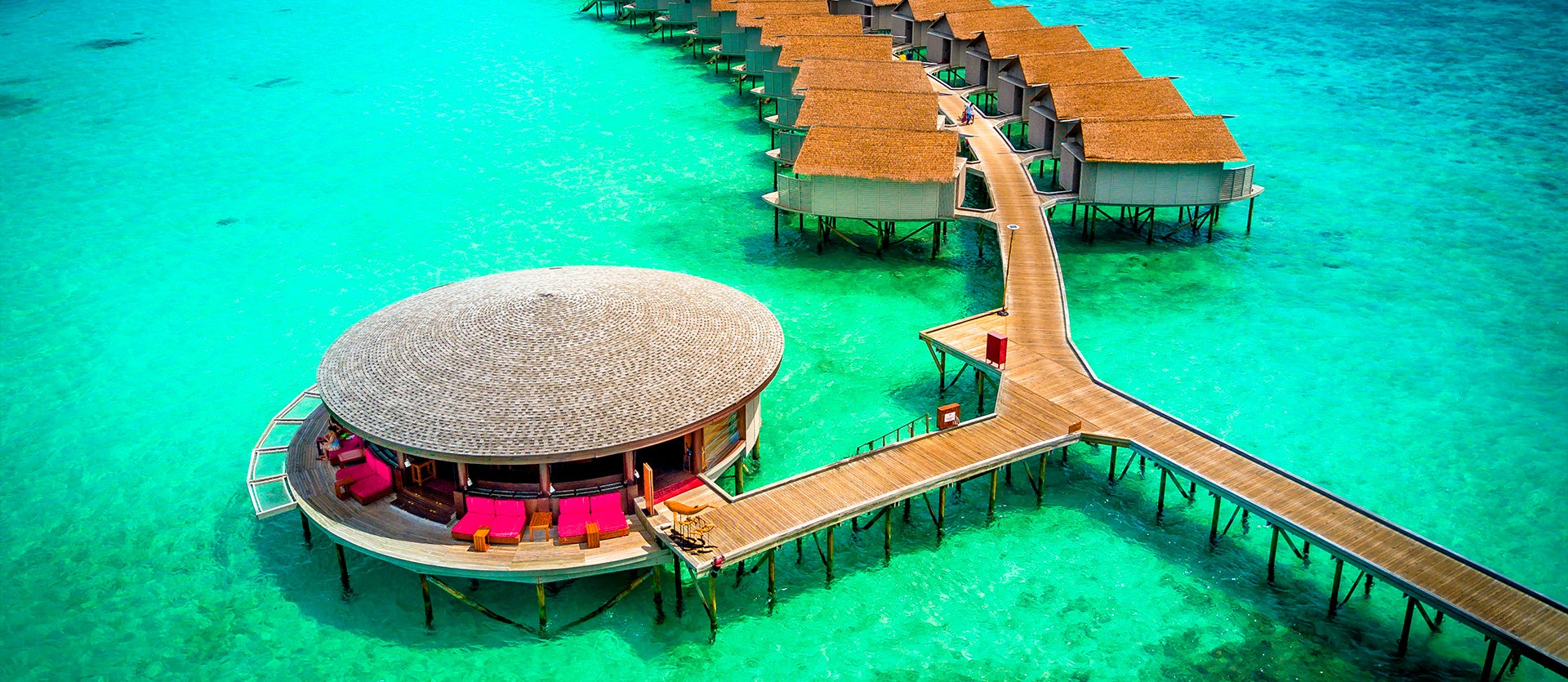 Overwater bungalows with turquoise waters in the Maldives